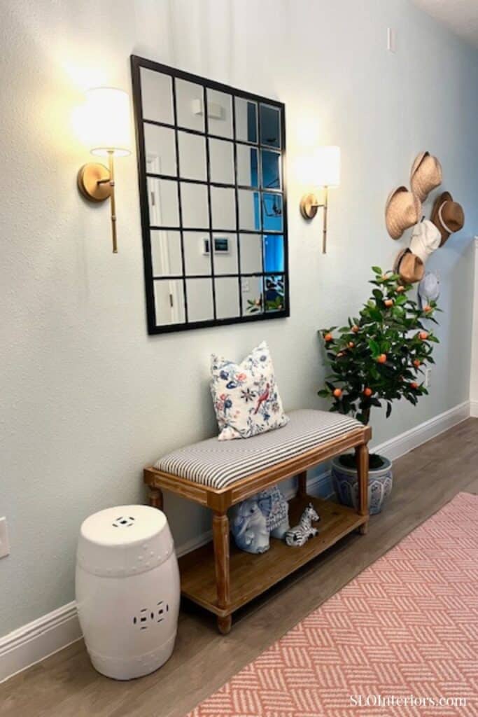Light aqua entryway with mirror and bench