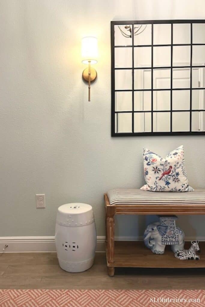 Entryway with wood bench and white garden stool