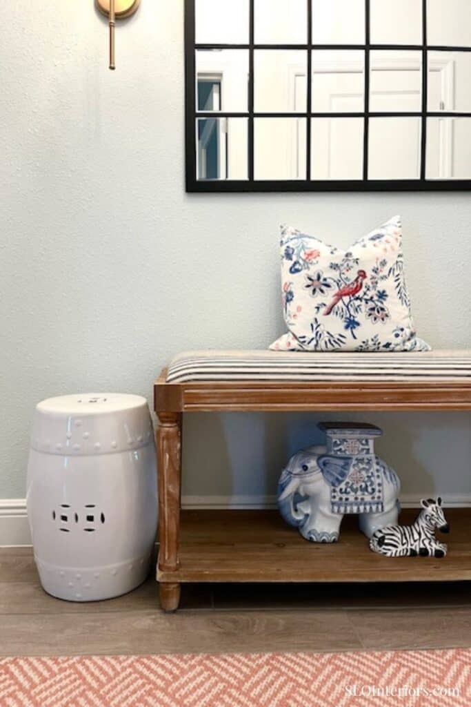 Entryway bench with ceramic elephant and zebra