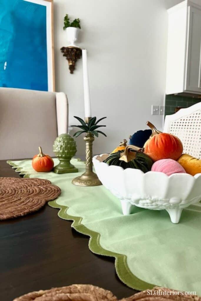 Close up of white vintage bowl with velvet pumpkins