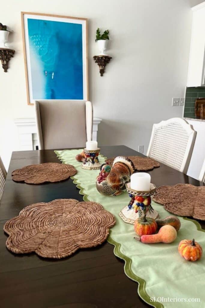Traditional fall tablescape with ceramic turkey and faux pumpkins