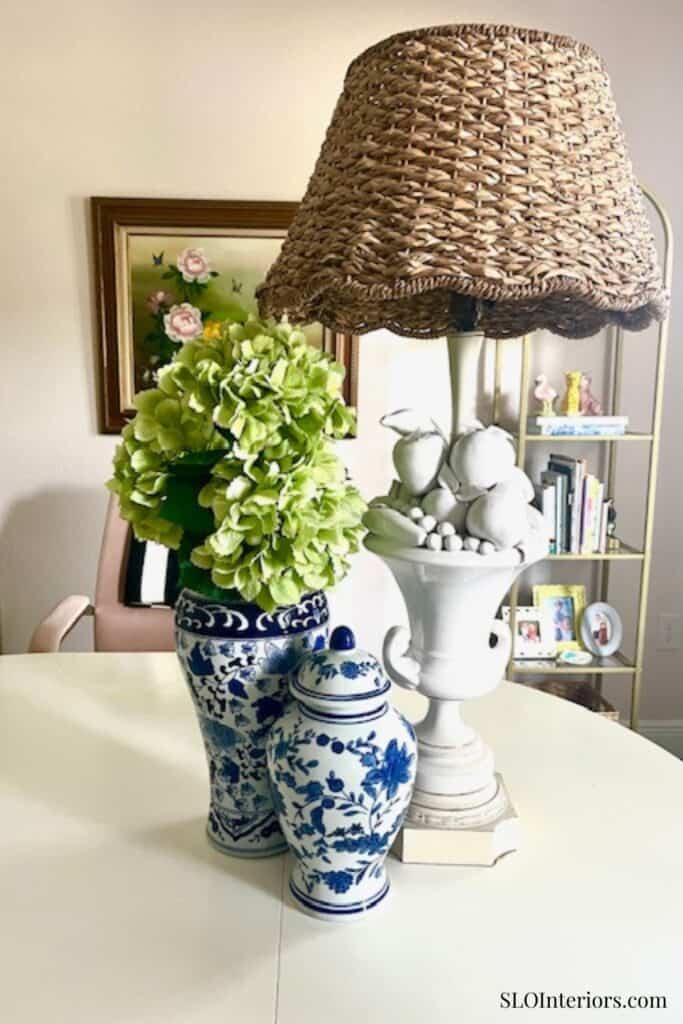 Two blue floral vases and a white ceramic lamp with woven shade