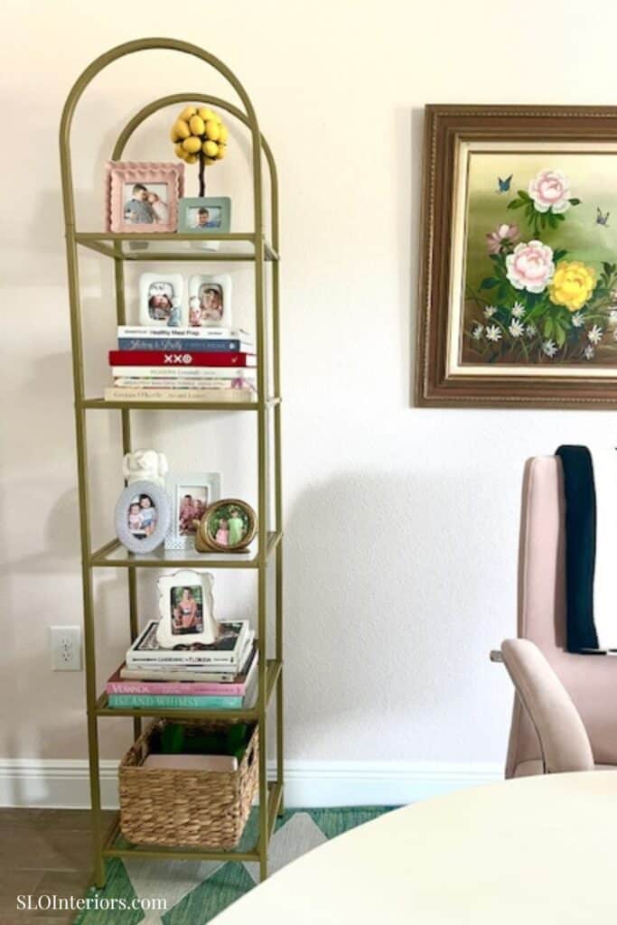 Close up of a book shelf with frames and books
