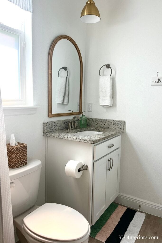 Simple white bathroom with wood and gold accents