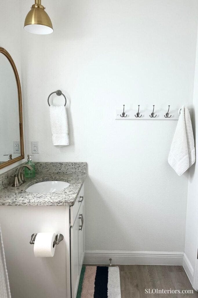 White bathroom with towel ring and hook rail
