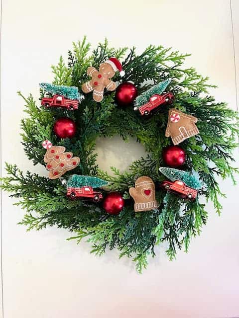 Faux boxwood wreath with gingerbread ornaments