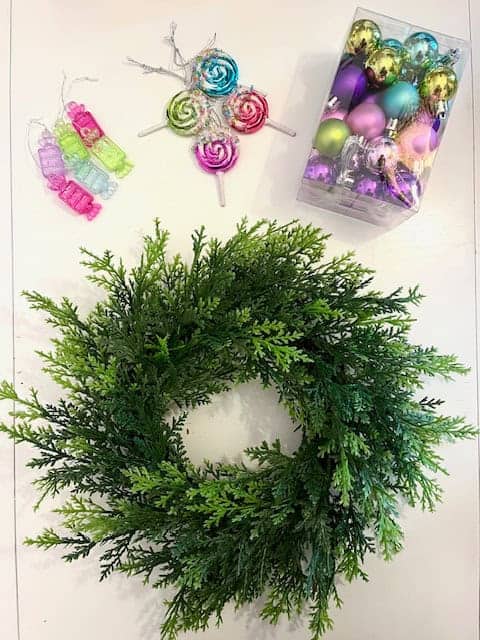 Faux boxwood wreath with pink, purple, green and blue ornaments