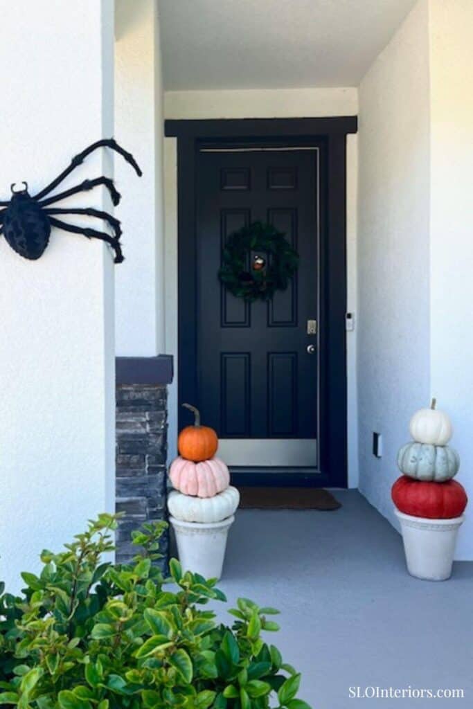 Front porch of white house with two pumpkin towers