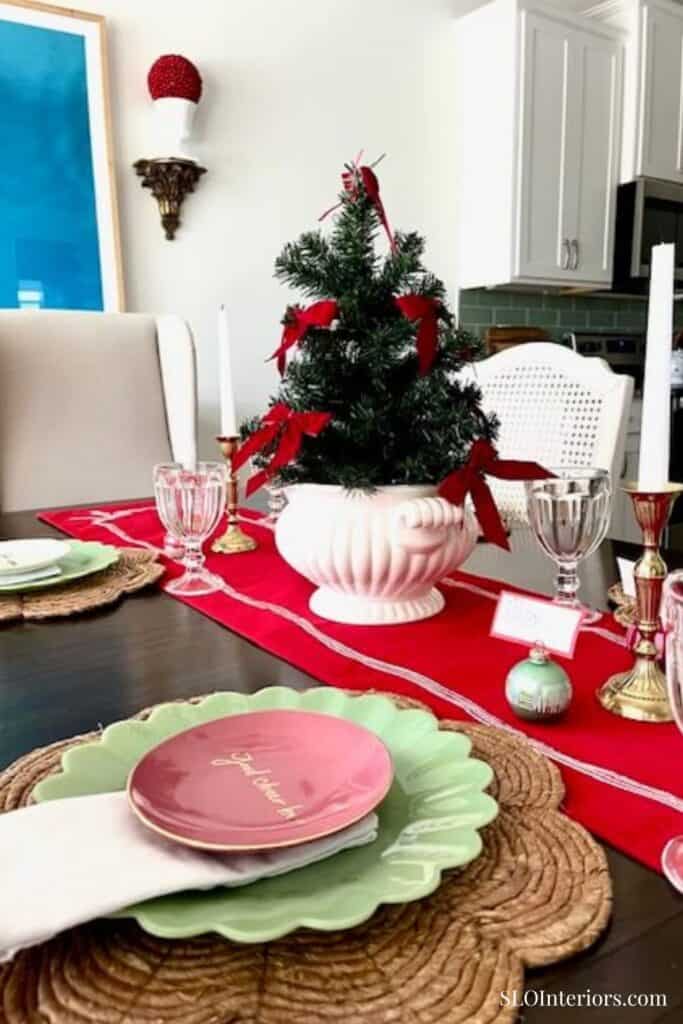 Christmas table setting with red runner and colorful place settings