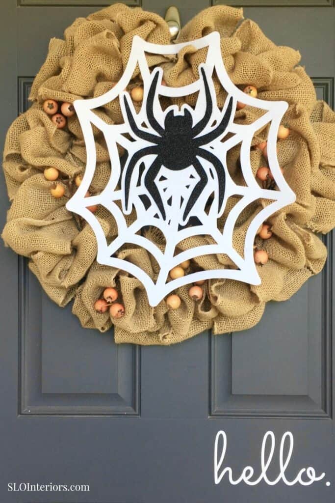 Festive Halloween door wreath with spider and web decoration, welcoming guests.