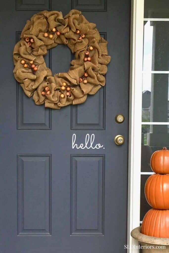 Warm fall wreath on navy front door with pumpkins and "hello" sign, SLO Interiors.