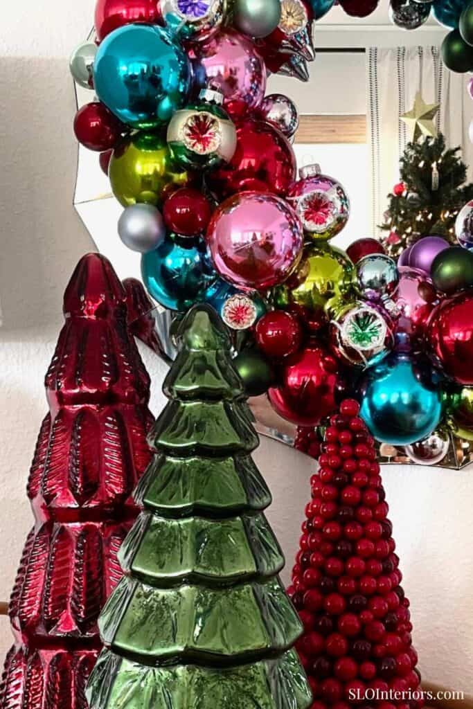 A colorful Christmas ornament display with glass trees and baubles at SLO Interiors.