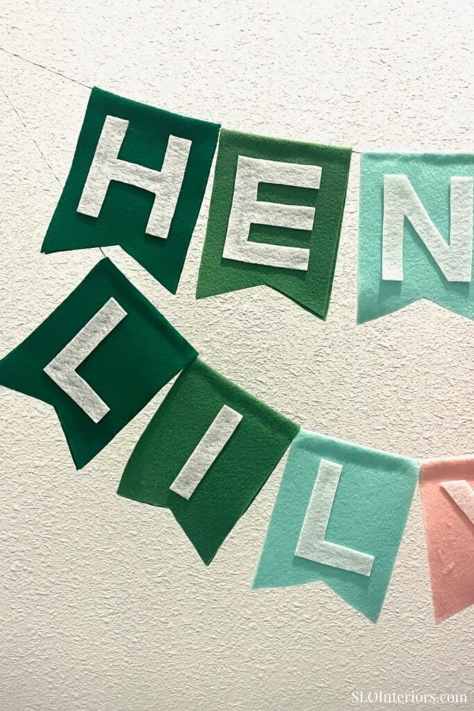 HENLEIL banner with colorful felt letters for home decor or celebration.