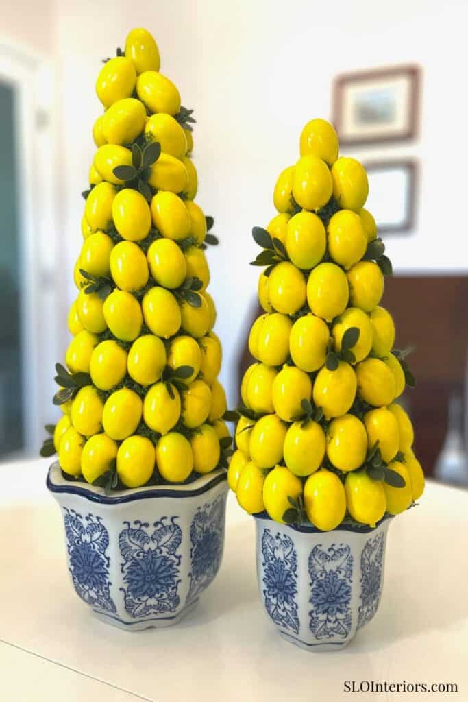 Decorative lemon topiary arrangements in blue and white planters.
