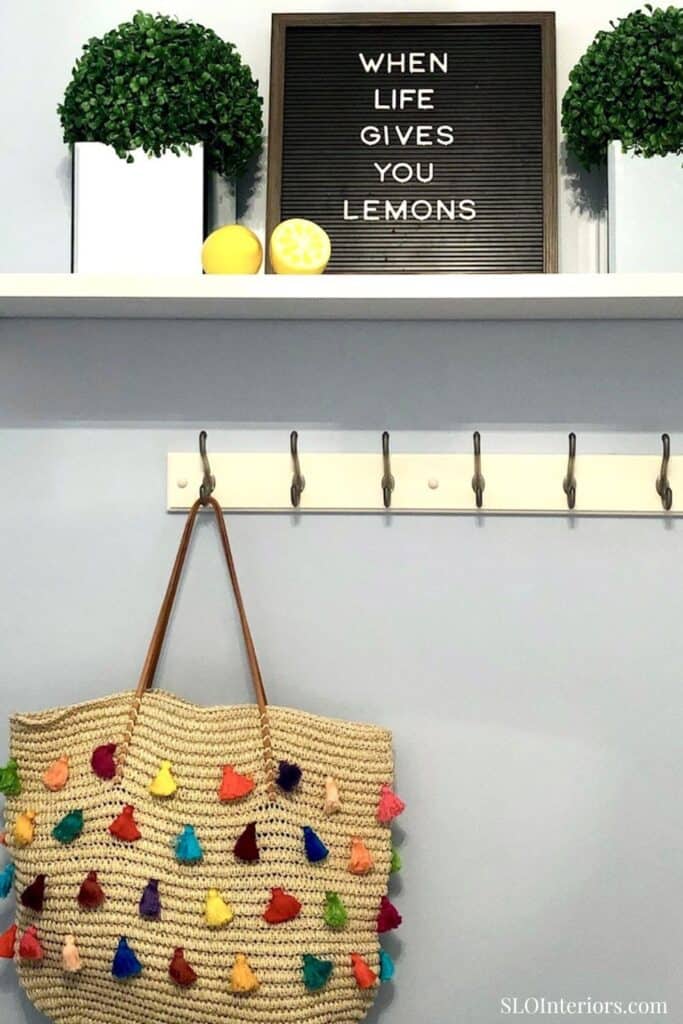 Bright interior decor with lemons, greenery, and a colorful woven bag at SLO Interiors.