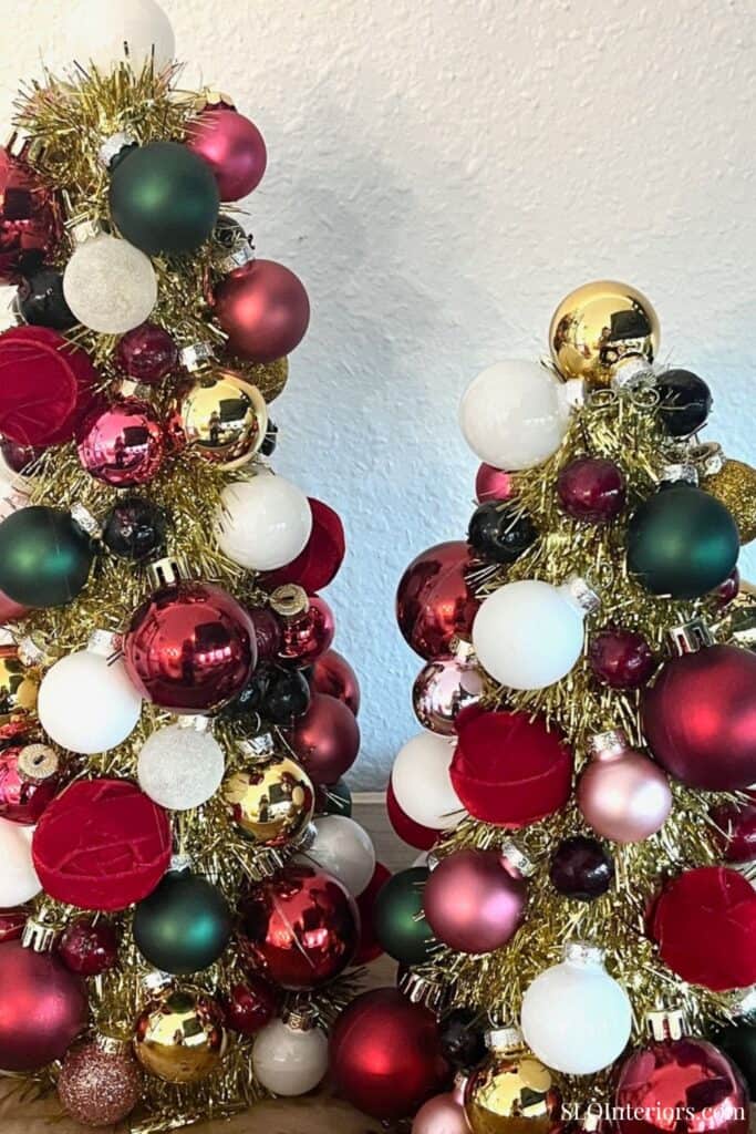 Festive Christmas trees decorated with colorful ornaments and gold tinsel.