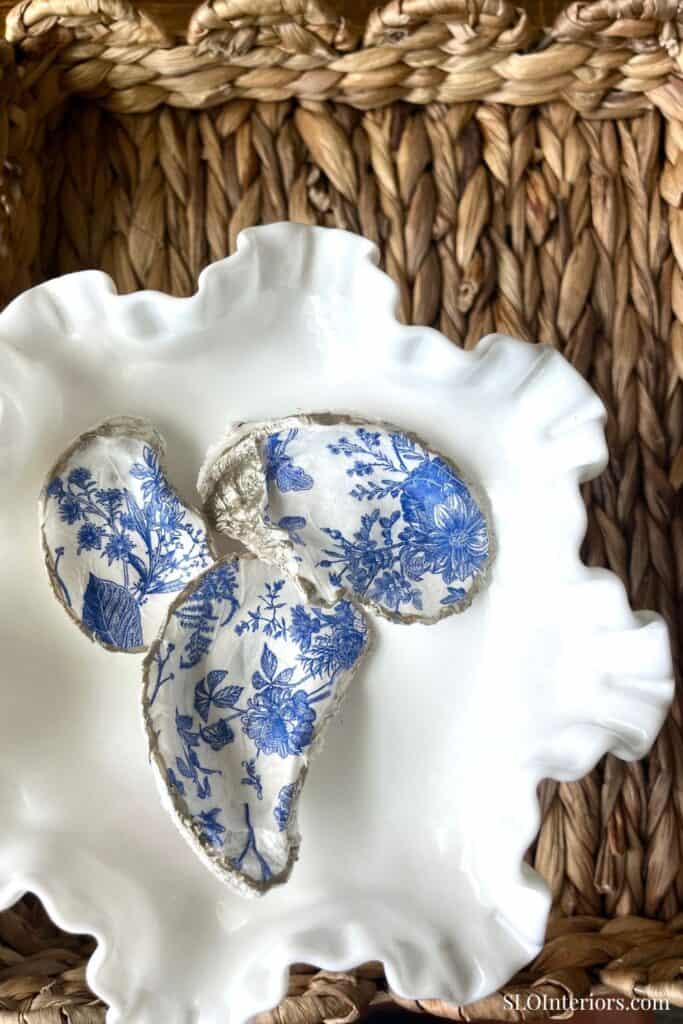 Elegant floral fabric butterfly decor on white ceramic dish, natural woven background.