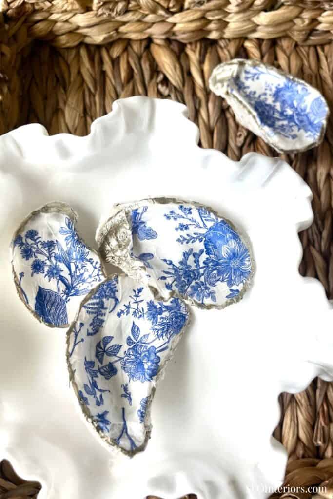 Vintage blue and white floral porcelain shards on textured woven background.