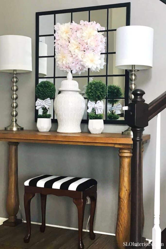 Elegant floral decor with vases and lamps in a stylish interior setting.