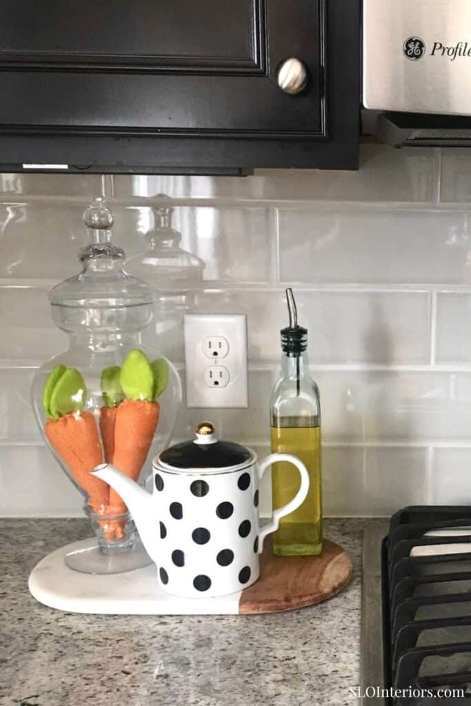 A cozy kitchen countertop with black and white decor and glass jars.