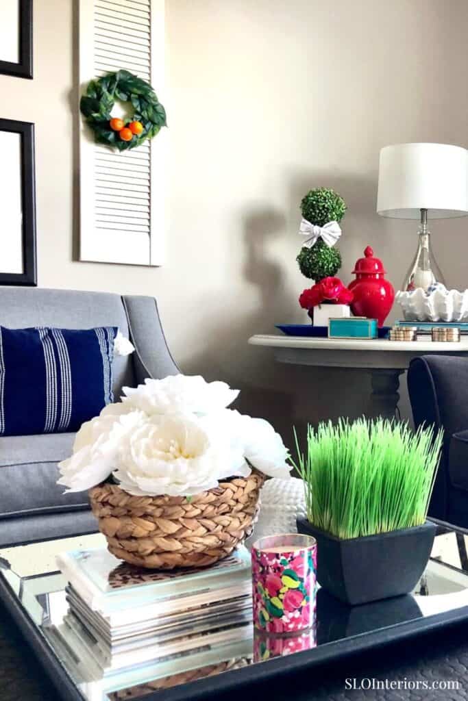 Elegant living room decor with floral arrangements and modern accessories, SLO Interiors.
