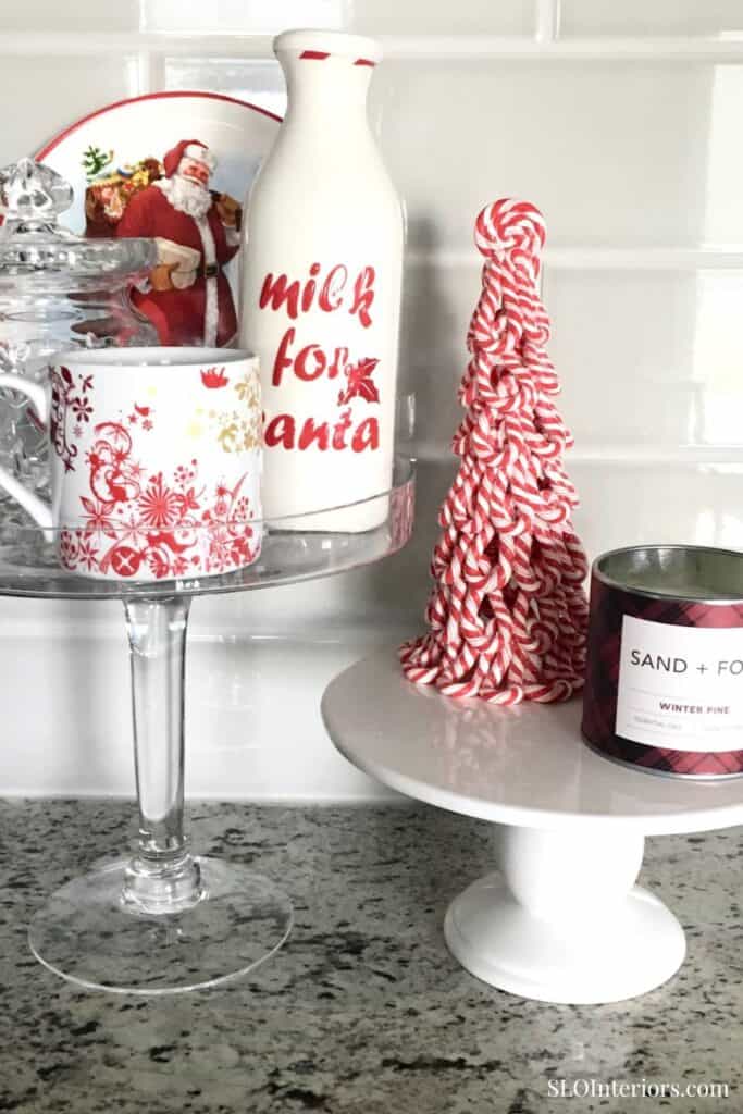 A festive holiday display with Christmas-themed decor, including a milk bottle, candy cane tree, and.