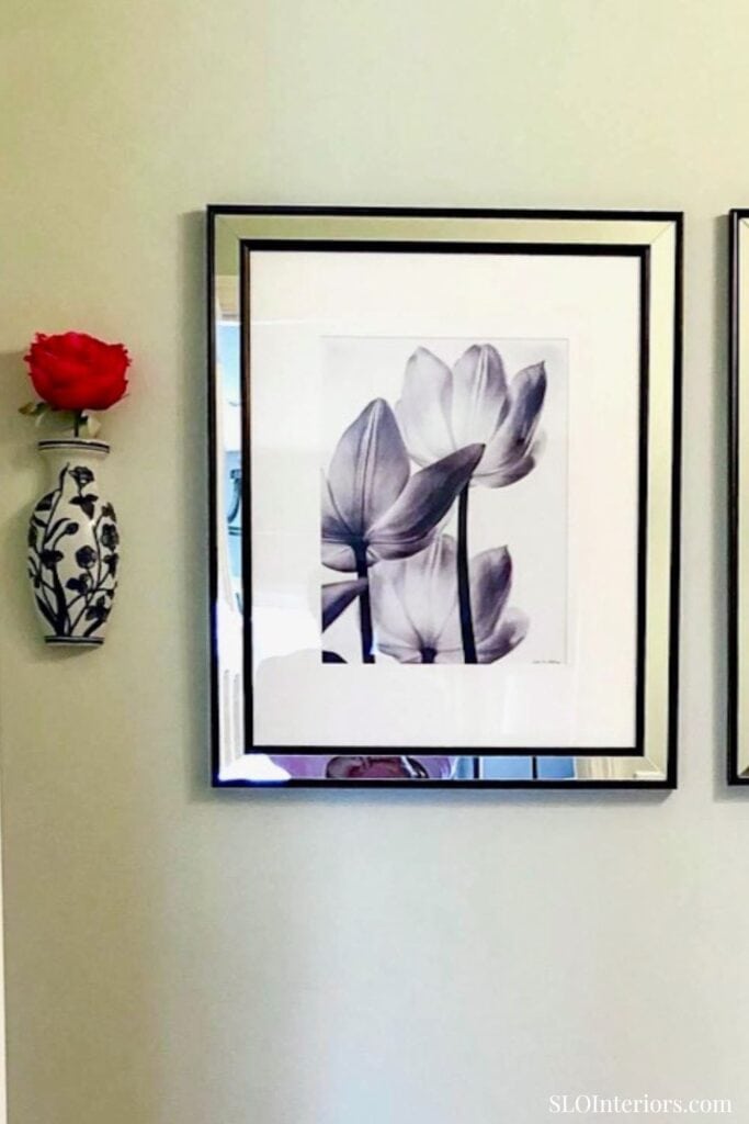 Elegant framed floral artwork with wall-mounted vase and red flower decor.