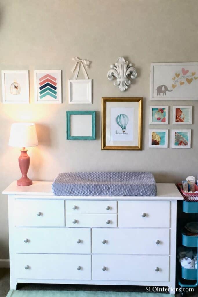 A colorful nursery changing table with wall art and decor, modern interior design.