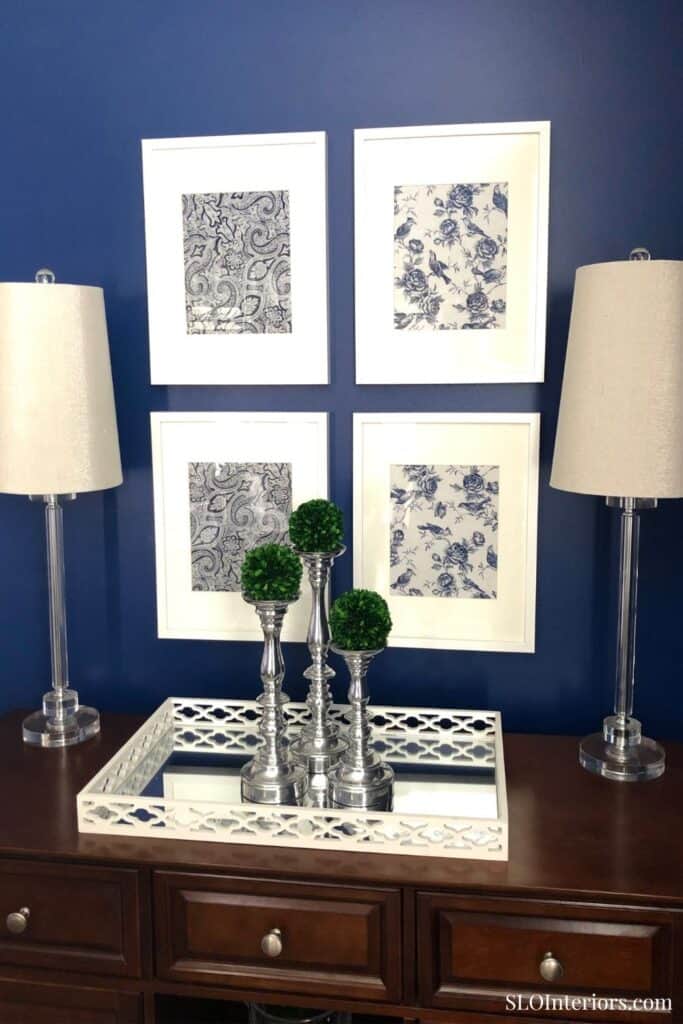 Elegant blue and white floral wall art with lamps and decorative vases in a modern interior.
