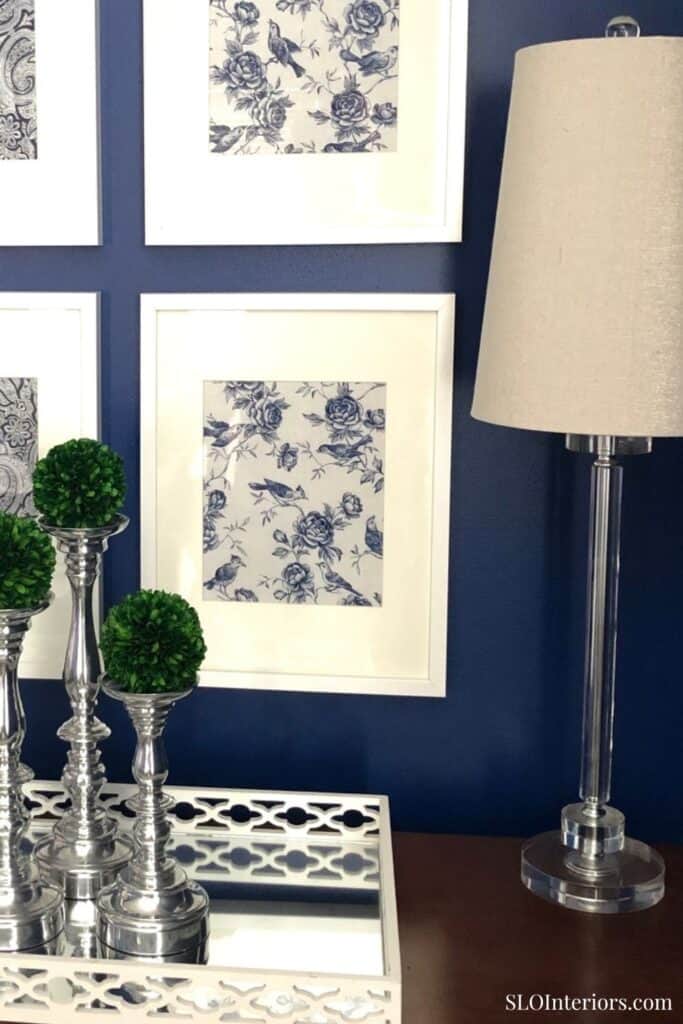 Elegant blue and white floral wall art with decorative greenery and modern lamp.