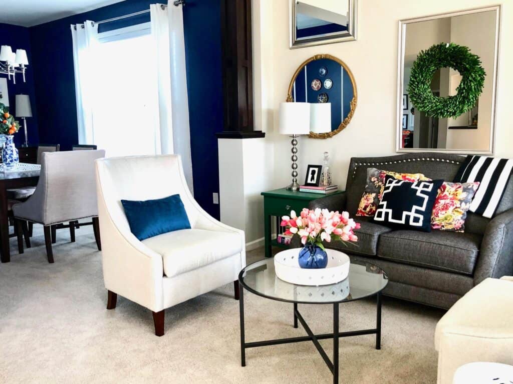 A cozy living room with modern decor, green wreath, and stylish furniture.