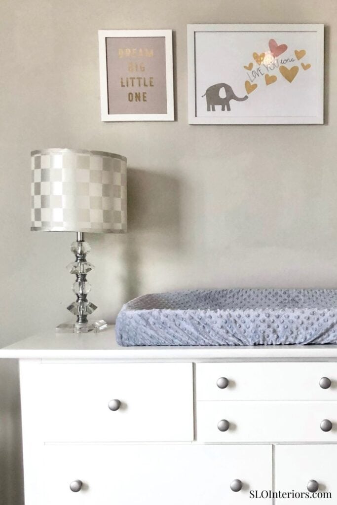 Dream big little one nursery decor with changing table and wall art.