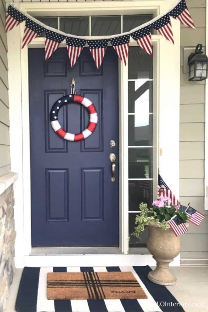 Patriotic front door decor with American flags and wreath, SLO Interiors.