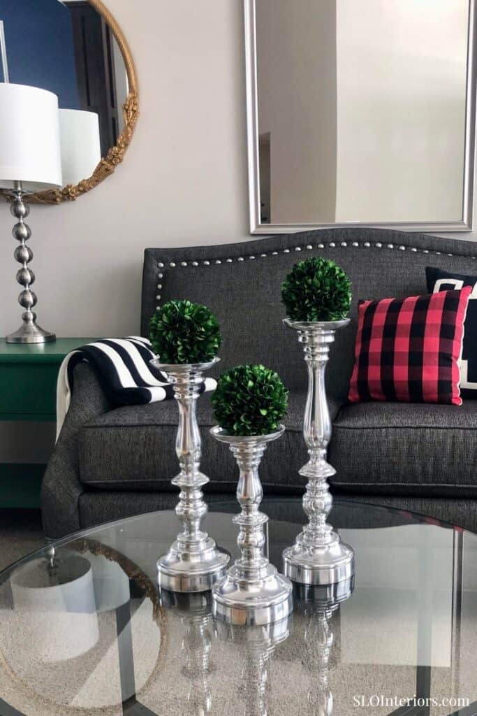 Elegant living room with modern decor, gray sofa, and decorative candles.