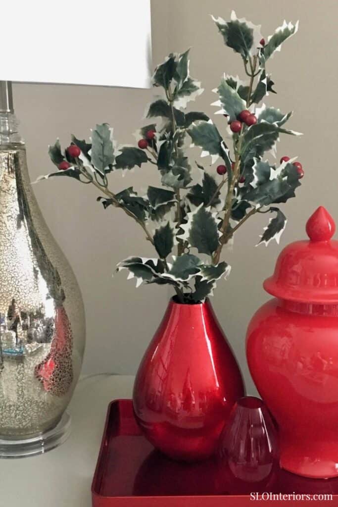 Holly branch in red vase with holiday decor, Christmas interior design, SLO Interiors.