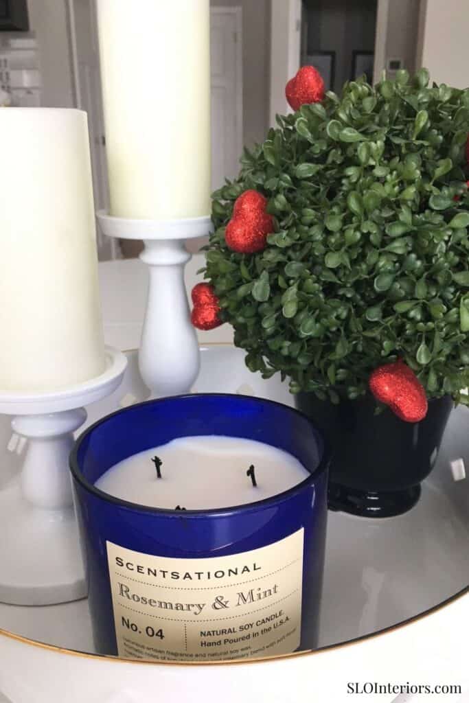 Rosemary and Mint scented candle with decorative greenery and strawberries in a modern interior sett.