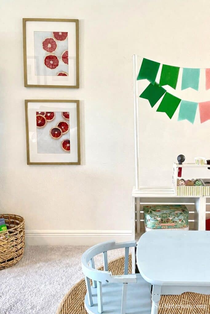 Freshly decorated interior with framed fruit art, colorful banners, and cozy seating.