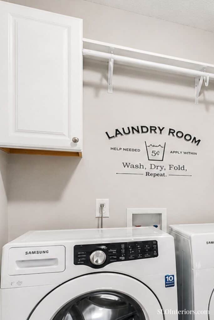 Wash, dry, fold laundry room with Samsung washer and white cabinets - SLO Interiors.