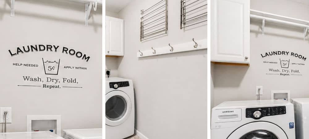 Clean and modern laundry room with washer, dryer, and wall hooks for organization.
