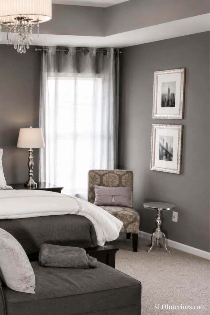 Elegant bedroom with gray walls, white bedding, and modern decor, SLO Interiors.