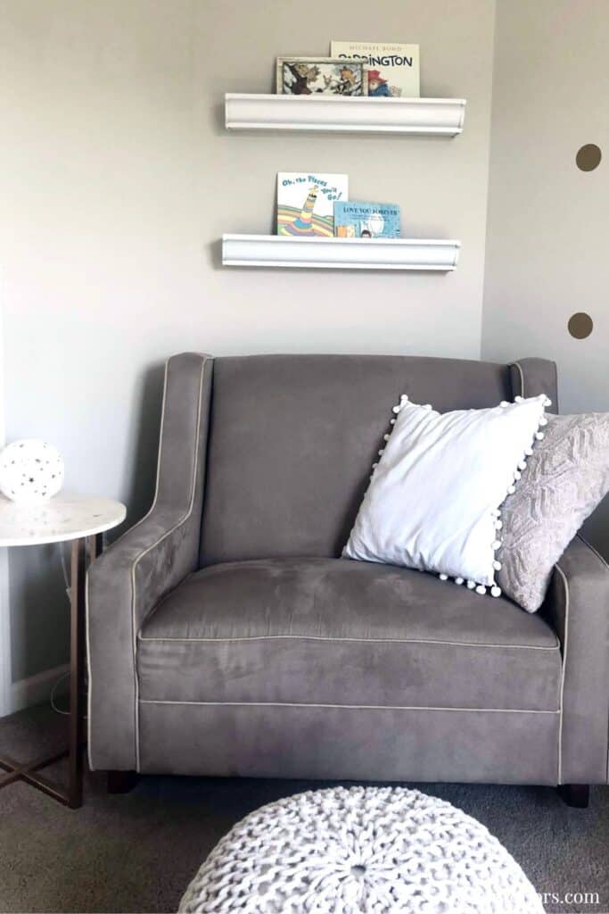 Modern gray sofa with white and gray pillows in stylish living room.