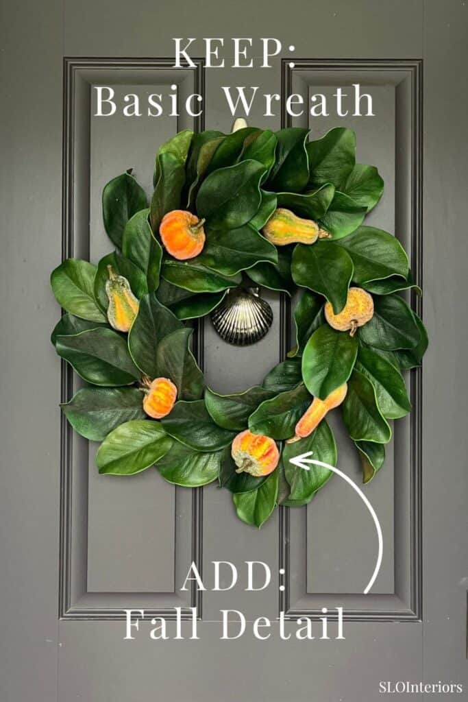 Fall-themed wreath with green leaves and orange accents on a gray door.