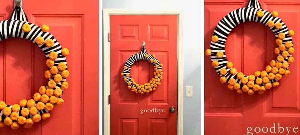 A colorful Halloween-themed door wreath with black and white striped ribbon and orange pom-poms.