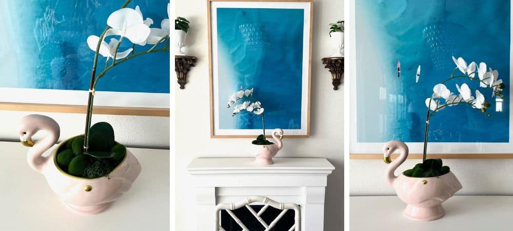 A colorful floral arrangement with white orchids in a pink swan-shaped vase, modern interior decor.