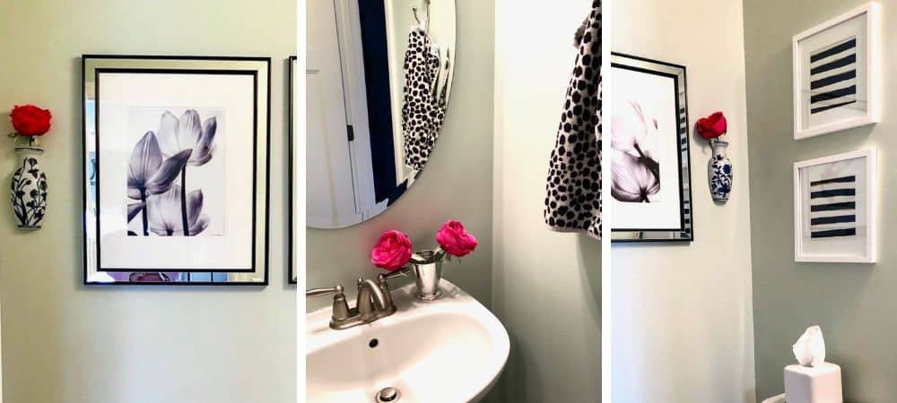 Elegant bathroom decor with floral artwork and modern accessories.
