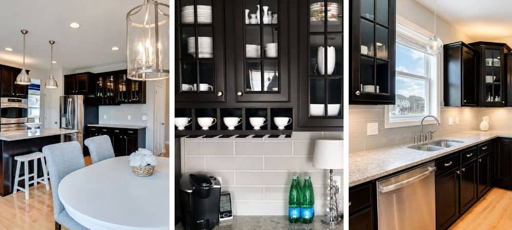 Modern black kitchen cabinets with white countertops and stylish decor.