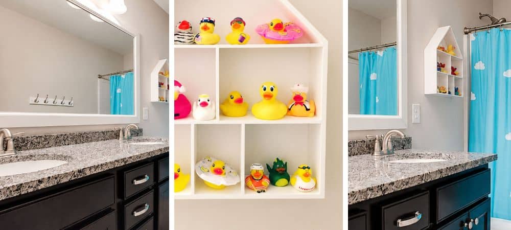 Bathroom with black vanity, large mirror, and blue shower curtain, decorated with rubber duckies.